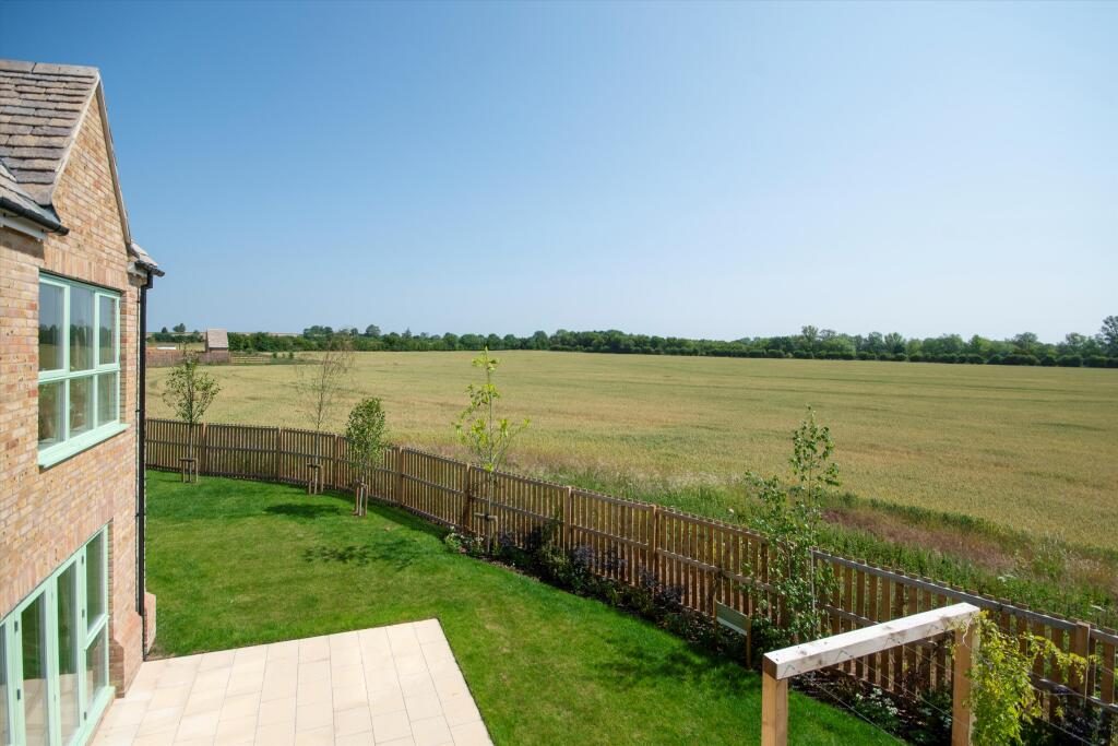 Source listing photo: rear garden view of a Cotswolds new-build home